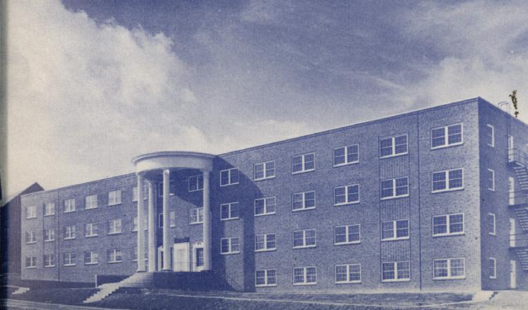Historical black and white photo of the front of Feagin Hall at East Texas Baptist University, a red brick building with white columns.