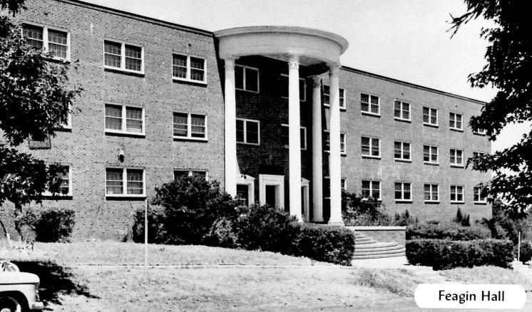 Historical black and white photo of the front of Feagin Hall at East Texas Baptist University, a red brick building with white columns.