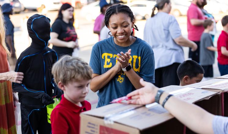 A fall festival with people playing games with small children