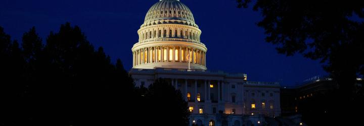 An evening shot of the U.S. Capital in Washington D.C. lit up against a night sky.