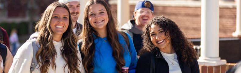 A group of women outside smiling and walking together